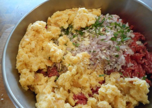 In der Zwischenzeit das Knödelbrot in etwas Wasser einweichen. Wenn es weich ist, das Faschierte, zwei Eier, Senf, Salz, Pfeffer, gehackte Petersilie und alle anderen Gewürze dazugeben ... 