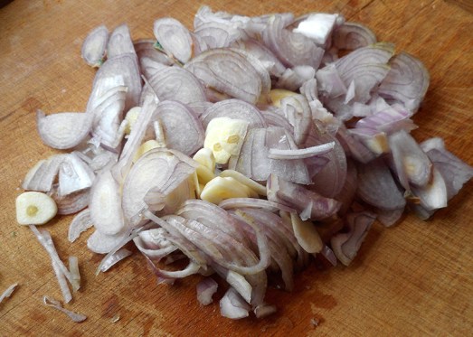 Kartoffeln, Zwiebel und Knoblauch blättrig schneiden, Rindfleisch kleinschneiden.